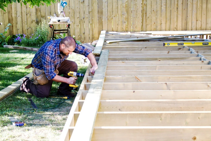 Professional crew installing a custom backyard deck in a Houston residential property