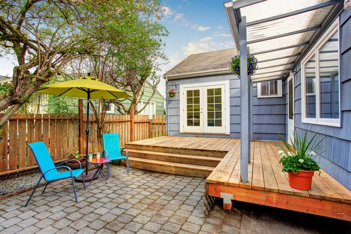 Experienced Houston custom deck builders discussing outdoor deck plans with homeowners